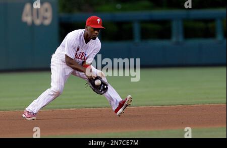 Philadelphia Phillies short stop Jimmy Rollins leaps into the air after  forcing Atlanta Braves runner Kelly Johnson at second base and completes  the double play in the seventh inning at Turner Field