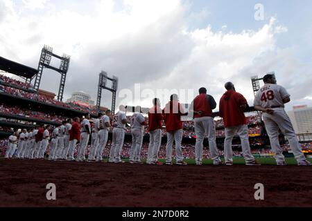 Several St. Louis Cardinals players stand for the National Anthem before a  game against the Milwaukee Brewers in high socks at Busch Stadium in St.  Louis on May 19, 2013. The team