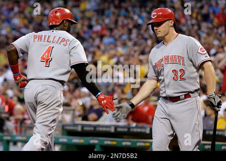 Cincinnati Reds' Brandon Phillips, right, is greeted at home plate by  teammate Royce Clayton (2) after hitting a home run off Los Angeles Dodgers  pitcher Mark Hendrickson in the second inning of