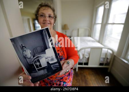 https://l450v.alamy.com/450v/2n7d8p4/in-this-may-15-2013-photo-patricia-hall-holds-a-photograph-of-her-grandmother-gladys-johnson-while-standing-in-the-5-by-14-room-that-lee-harvey-oswald-rented-in-1963-at-her-familys-boarding-house-in-dallas-oswald-stayed-at-the-red-brick-house-with-white-trim-during-the-week-while-working-his-new-job-at-the-texas-school-book-depository-and-on-the-weekends-he-returned-to-the-suburb-of-irving-where-his-wife-lived-hall-said-shes-been-considering-selling-the-house-for-years-but-decided-the-time-was-right-as-this-year-marks-the-50th-anniversary-of-kennedys-assassination-in-downtown-dallas-2n7d8p4.jpg