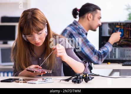 The two technicians working at computer warranty center Stock Photo