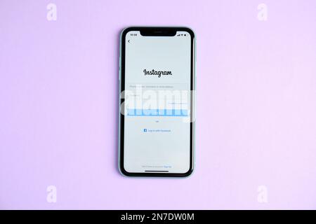 MYKOLAIV, UKRAINE - JULY 10, 2020: Iphone 11 with Instagram app on violet background, top view Stock Photo