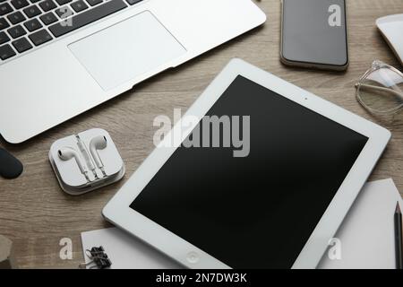 MYKOLAIV, UKRAINE - JULY 20, 2020: Composition with iPhone 11 and different Apple gadgets on wooden table Stock Photo