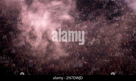 Spectators are briefly blocked by smoke while watching an Argentina's league soccer match between River Plate and Atletico Rafaela in Buenos Aires, Argentina, Sunday, May 26, 2013. (AP Photo/Natacha Pisarenko)