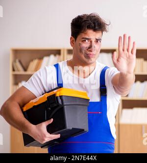 The funny man doing electrical repairs at home Stock Photo