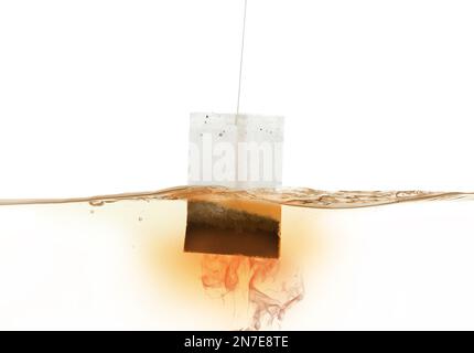 Dipping of tea bag into hot water against white background Stock Photo