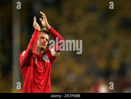 FILE - In this June 20, 2006, file photo, England's captain David Beckham acknowledges fans after their 2-2 draw with Sweden in a World Cup Group B soccer match at the World Cup Stadium in Cologne, Germany. The 38-year-old midfielder, who recently won a league title in a fourth country with Paris Saint-Germain, said Thursday, May 16, 2013, he will retire after the season. (AP Photo/Kevork Djansezian, File)