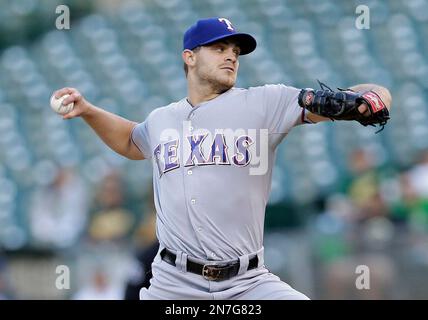 Texas Rangers catcher A.J. Pierzynski (12) and second baseman Ian Kinsler,  center, visit starting pitcher Justin Grimm (51) on the mound in the fifth  inning of a baseball game against the Oakland