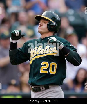 Oakland Athletics' Josh Donaldson reacts while batting while Seattle  Mariners catcher Mike Zunino picks up the ball during a baseball game in  Seattle on Saturday, Sept. 28, 2013. (AP Photo/John Froschauer Stock