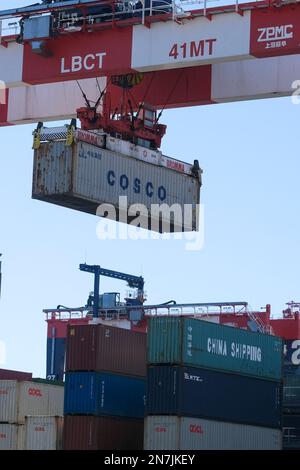 A large crane lifts shipping containers onto trucks at the Long Beach Container Terminal (LBCT). The LBCT $2.5 billion investment that has enabled one of the world's top port terminal operators to significantly reduce emissions and have “net zero” within its grasp. This tour will also reveal for the first time more details of a $30 million project at LBCT to deploy zero-emission cargo handling equipment and an exclusive look at LBCT's plans to fully decarbonize operations by 2030. (Photo by Ringo Chiu/SOPA Images/Sipa USA) Stock Photo