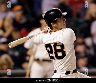 FILE - In this Aug. 10, 2018, file photo, San Francisco Giants' Buster  Posey hits a two-run single off Pittsburgh Pirates starting pitcher Clay  Holmes during the third inning of a baseball