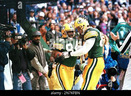 Green Bay Packers wide receiver Sterling Sharpe (84) is congratulated by  teammate Mark Chmura (89) after a third-quarter touchdown against the  Dallas Cowboys in Irving, Tex., Nov. 24, 1994. Sharpe scored four