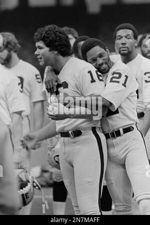 Oakland Raiders wide receiver Cliff Branch (21) embraces quarterback Jim  Plunkett (16) as the Raiders lined up for a team picture before a workout  in the Superdome in New Orleans, Jan. 21