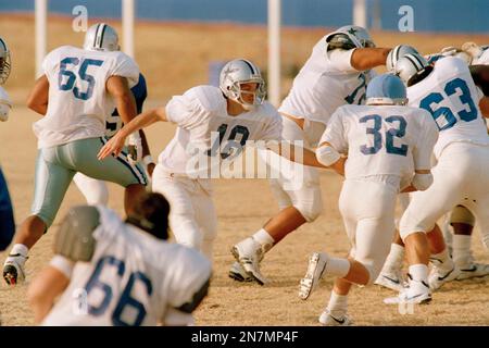 Dallas Cowboys quarterback Bernie Kosar (18) prepares to pass, as offensive  tackle Erik Williams (7) holds of San Francisco 49ers' defensive end Larry  Roberts (91) in the third quarter of the NFC