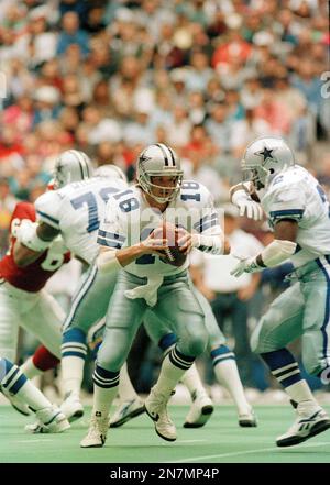 Dallas Cowboys quarterback Bernie Kosar (18) prepares to pass, as offensive  tackle Erik Williams (7) holds of San Francisco 49ers' defensive end Larry  Roberts (91) in the third quarter of the NFC