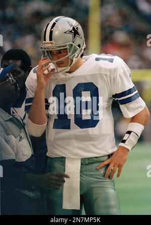 Dallas Cowboys quarterback Bernie Kosar (18) prepares to pass, as offensive  tackle Erik Williams (7) holds of San Francisco 49ers' defensive end Larry  Roberts (91) in the third quarter of the NFC