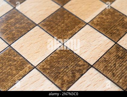 Empty wooden chessboard pattern. Top view. Board made of wood for playing chess. Chessboard texture background. Stock Photo
