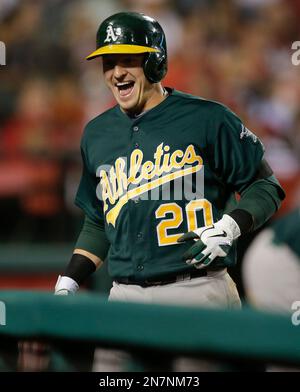 Oakland Athletics' Josh Donaldson reacts while batting while Seattle  Mariners catcher Mike Zunino picks up the ball during a baseball game in  Seattle on Saturday, Sept. 28, 2013. (AP Photo/John Froschauer Stock