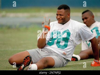 Miami Dolphins tight and Keith Jackson (88) celebrates the Dolphins 31-0  win over the San Diego Chargers in Miami, Jan. 10, 1993 as he passes  linebacker Dwight Hollier (50) after the game.