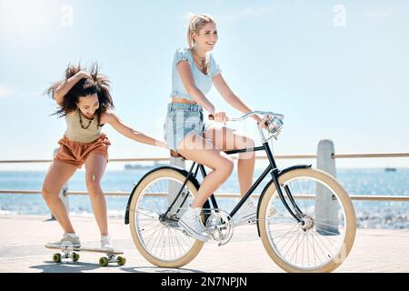 Having the most fun with friends. Full length shot of two friends bonding during a day outdoors. Stock Photo
