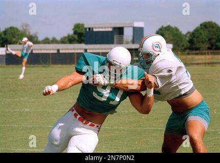 Miami Dolphins first-round pick John Bosa (97) eludes offensive lineman  Mark Dennis during his first workout with the team in Miami, Sept. 2, 1987.  Bosa signed with the team Tuesday, ending a 41-day holdout. Bosa, a  defensive end from Boston College, i