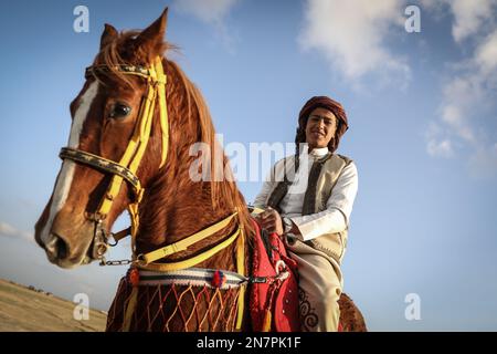 Borg El Arab, Egypt. 10th Feb, 2023. A Bedouin young man rides a horse during Horus race for birds of prey, organized by Egypt Falconers Club in the desert of Borg al-Arab near Alexandria. The race is named after the ancient Egyptian falcon-headed god 'Horus' and brings falconers from across Egypt to show their raptor's skills in hunting and flight speed. Credit: Gehad Hamdy/dpa/Alamy Live News Stock Photo