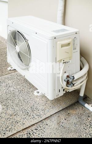 outdoor unit of split air conditioner for cooling, hanging on the wall Stock Photo