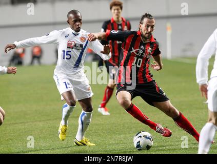 South Korea's FC Seoul striker Dejan Damjanovic, left, fights for the ball  against Al Ahli's Jose Marcio Da Costa, top right, and Osama Hawsawi during  their AFC Champions League quarterfinal second leg