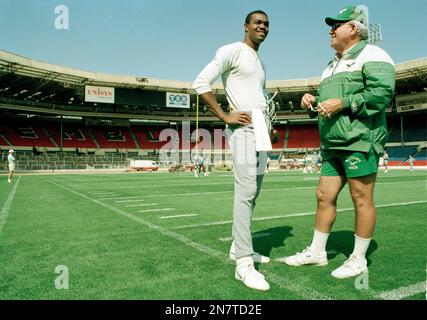 Philadelphia Eagles former quarterback Randall Cunningham enjoys a hearty  laugh as he holds his young son, Christian while being inducted into the  Eagles Honor Roll during half time ceremonies in Philadelphia at