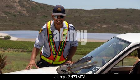 Western Cape, South Africa, 2023 SAPS South African police officer on a roadside drivers licence and insurance check Stock Photo