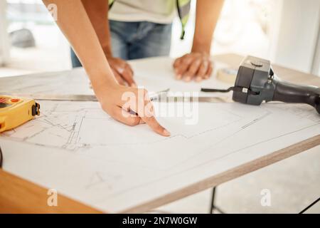 What was the theme for this room. two unrecognisable construction workers standing together and having a discussion while looking at building plans. Stock Photo