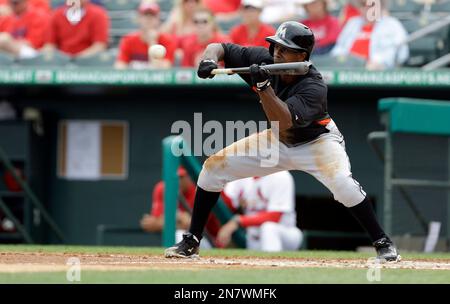 Miami Marlins Juan Pierre (9) takes a bunt against the New York Mets during  a spring training game at the Roger Dean Complex in Jupiter, Florida on  March 3, 2013. Miami defeated