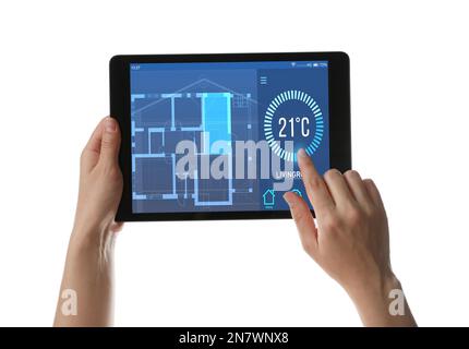 Woman using tablet to control heating system in house against white background, closeup Stock Photo