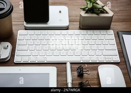 MYKOLAIV, UKRAINE - JULY 20, 2020: Composition with iPhone 11 and different Apple gadgets on wooden table Stock Photo