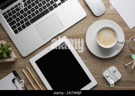 MYKOLAIV, UKRAINE - JULY 20, 2020: Flat lay composition with different Apple gadgets on wooden table Stock Photo