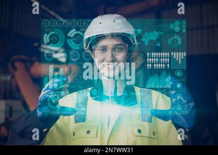 happy engineer female worker using advance technology digital hologram infographics touch panel in industry factory. Stock Photo