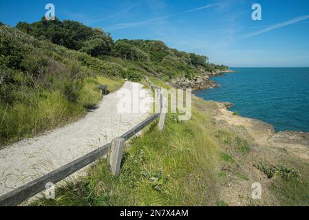 Coastal footpath on west Atlantic coast France, Ile d'Aix, Charente Maritime with rugged coastline and blue Atlantic ocean in summer Stock Photo