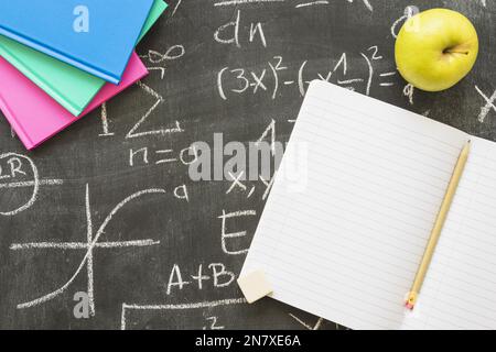 blackboard with books apple notebook Stock Photo