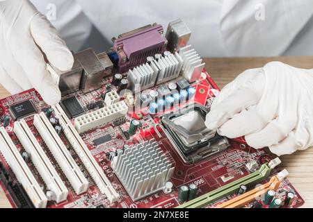 elevated view technician working computer motherboard Stock Photo