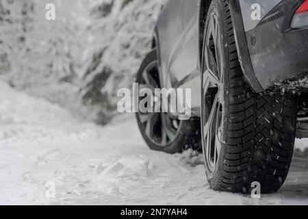 Close up shot of a car winter tire on s snow Stock Photo