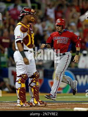 Puerto Rico's catcher Yadier Molina (4) chases down Japan's