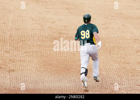 A's Josh Donaldson, (98) after hitting his first inning home run, turns to  reveal his jersey number 98 because he forgot his assigned number 20 jersey,  as he ended the day with