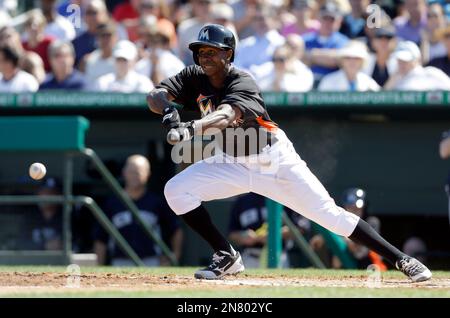 Miami Marlins Juan Pierre (9) takes a bunt against the New York Mets during  a spring training game at the Roger Dean Complex in Jupiter, Florida on  March 3, 2013. Miami defeated