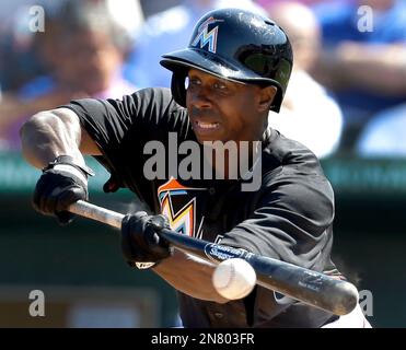 Miami Marlins Juan Pierre (9) takes a bunt against the New York Mets during  a spring training game at the Roger Dean Complex in Jupiter, Florida on  March 3, 2013. Miami defeated