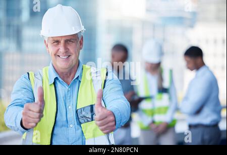 Always give it your best. a senior building foreman giving the thumbs up during a meeting. Stock Photo