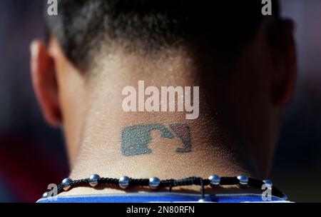 A Major League Baseball tattoo is seen on the neck of Chicago Cubs