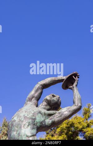 Athens, Greece - September 25, 2021: Bronze discobolus sculpture atlete in front of he Panathenaic Stadium or Kallimarmaro in Athens in Greece Stock Photo