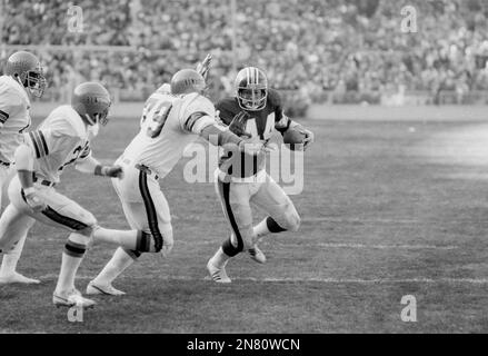 Washington Redskins full back John Riggins (44) runs over Cincinnatti  Bengal linebacker Jim LeClair (55) during