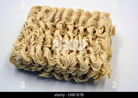 Quick cooking product, food, vermicelli, thin noodles in dry form is located on a white background. Stock Photo