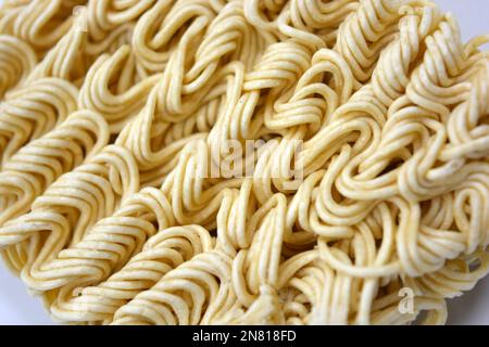 Quick cooking product, food, vermicelli, thin noodles in dry form is located on a white background. Stock Photo